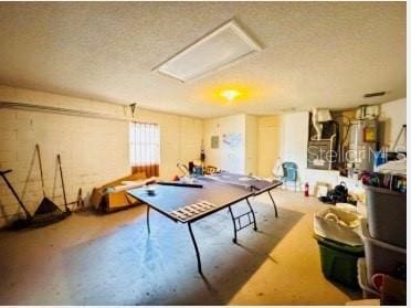 game room featuring a textured ceiling