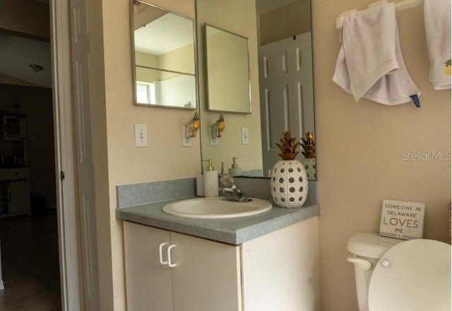 bathroom featuring vanity and toilet
