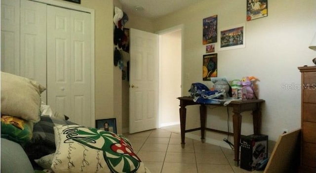 bedroom featuring a closet and light tile patterned flooring