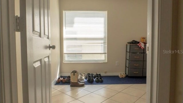 entryway with tile patterned floors and baseboards
