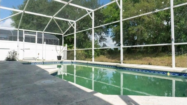 pool featuring a lanai and a patio area