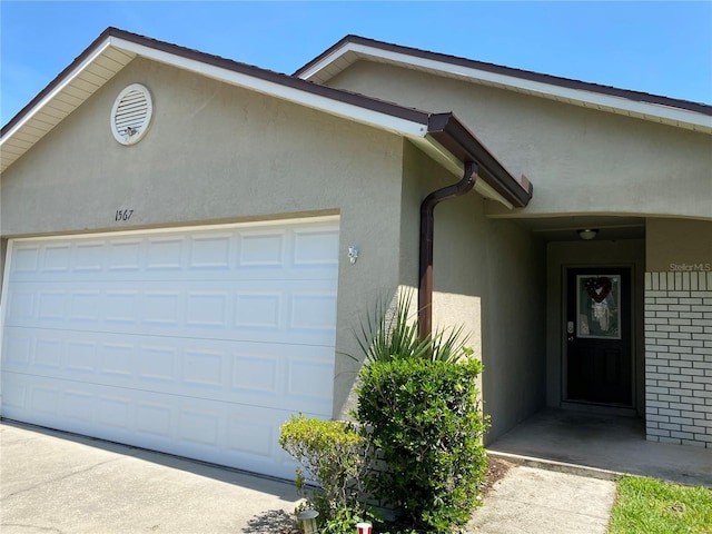 1567 Oak Hill Trl, Kissimmee, FL 34747 - view of front of property with stucco siding and an attached garage