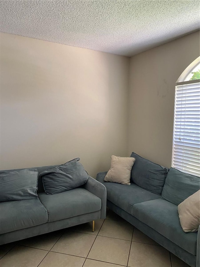 1567 Oak Hill Trl, Kissimmee, FL 34747 - living room with light tile patterned floors and a textured ceiling