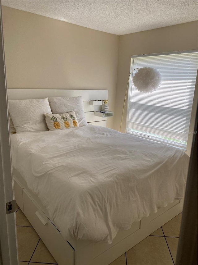 1567 Oak Hill Trl, Kissimmee, FL 34747 - bedroom featuring light tile patterned floors and a textured ceiling