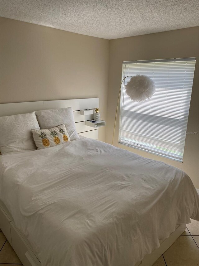 1567 Oak Hill Trl, Kissimmee, FL 34747 - bedroom with light tile patterned floors and a textured ceiling