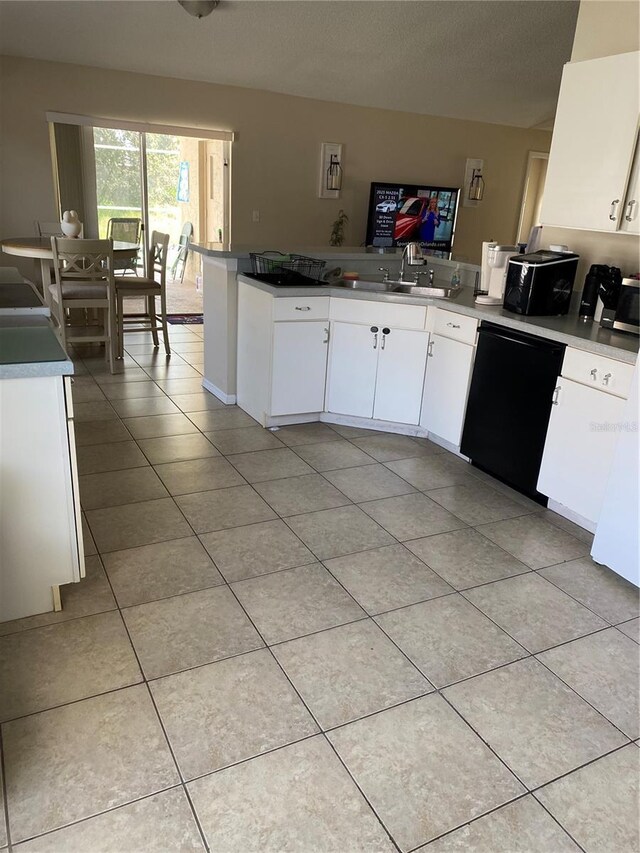 1567 Oak Hill Trl, Kissimmee, FL 34747 - kitchen with dishwasher, a sink, white cabinets, light tile patterned floors, and a peninsula