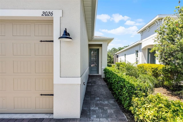 view of exterior entry with stucco siding