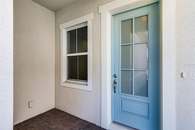 entrance to property with stucco siding