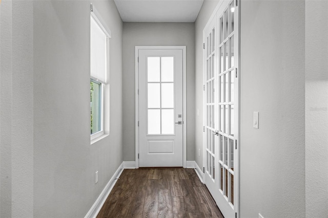 doorway featuring dark wood finished floors and baseboards