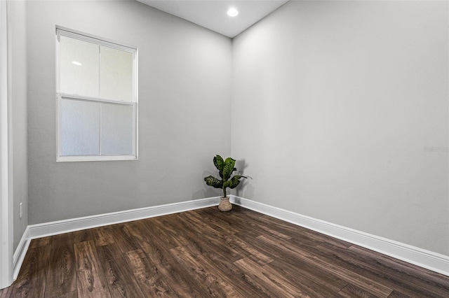unfurnished room with baseboards, recessed lighting, and dark wood finished floors