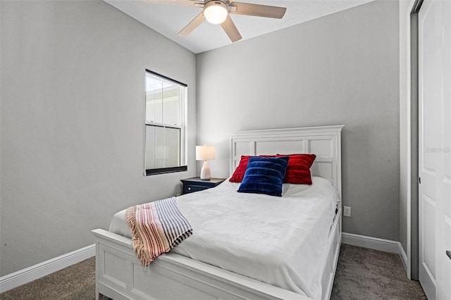 bedroom featuring dark colored carpet, baseboards, and ceiling fan