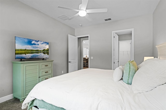bedroom with a walk in closet, baseboards, visible vents, and ceiling fan