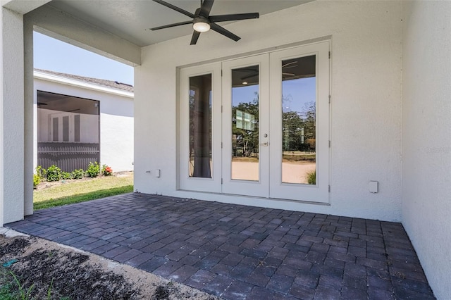 doorway to property featuring a patio area, a ceiling fan, french doors, and stucco siding
