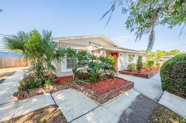 ranch-style home featuring fence