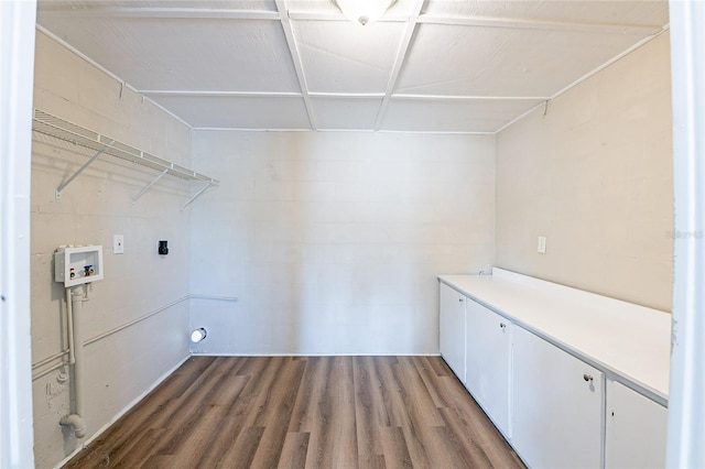 laundry room with electric dryer hookup, cabinet space, wood finished floors, and hookup for a washing machine