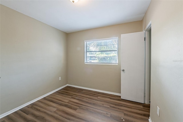 unfurnished room featuring wood finished floors and baseboards