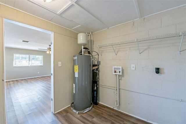 utility room featuring water heater and visible vents