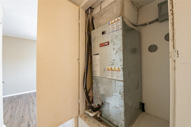 utility room featuring heating unit