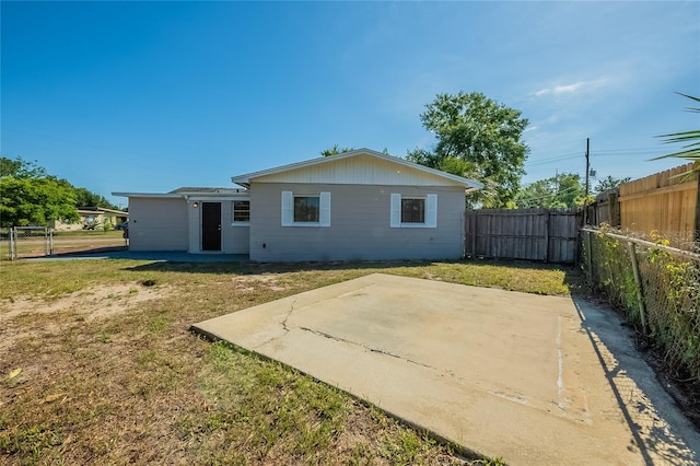 back of house with a patio area, a yard, and a fenced backyard