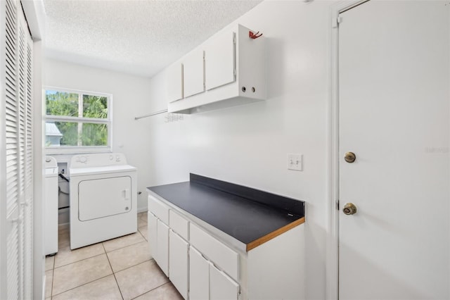11352 Persimmon Blvd, West Palm Beach, FL 33411 - washroom featuring washer / dryer, a textured ceiling, light tile patterned floors, and cabinet space