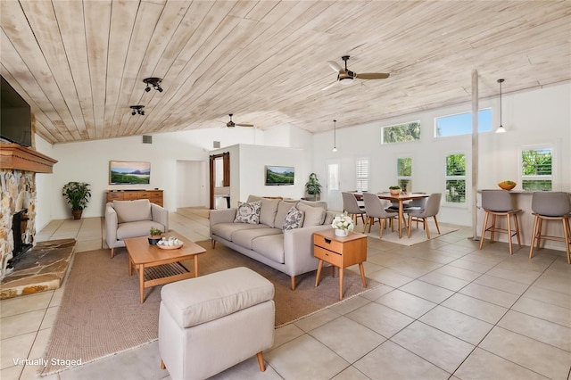 11352 Persimmon Blvd, West Palm Beach, FL 33411 - living area with ceiling fan, light tile patterned floors, lofted ceiling, a stone fireplace, and wooden ceiling
