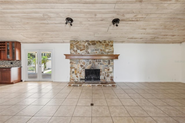 11352 Persimmon Blvd, West Palm Beach, FL 33411 - unfurnished living room with light tile patterned flooring, french doors, a fireplace, and wood ceiling
