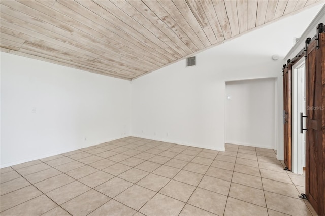 11352 Persimmon Blvd, West Palm Beach, FL 33411 - spare room featuring a barn door, wooden ceiling, vaulted ceiling, and light tile patterned flooring