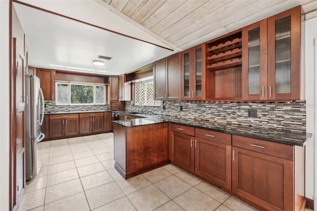 11352 Persimmon Blvd, West Palm Beach, FL 33411 - kitchen with freestanding refrigerator, light tile patterned flooring, a sink, backsplash, and vaulted ceiling