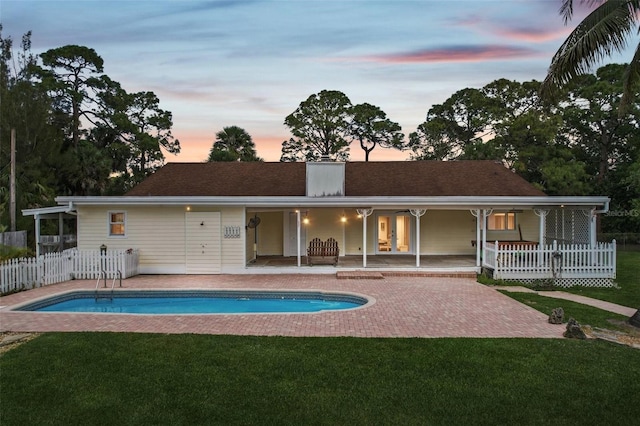 11352 Persimmon Blvd, West Palm Beach, FL 33411 - back of house at dusk with a patio and french doors