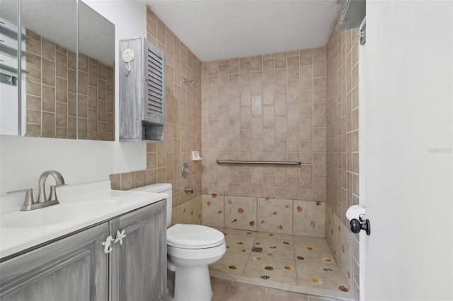 11352 Persimmon Blvd, West Palm Beach, FL 33411 - full bathroom with tiled shower, vanity, toilet, a textured ceiling, and tile patterned floors