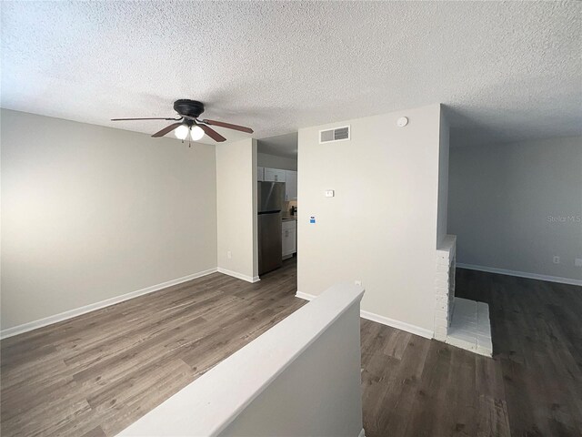 5126 Picadilly Circus Ct Unit 11, Orlando, FL 32839 - corridor with visible vents, a textured ceiling, baseboards, and dark wood finished floors