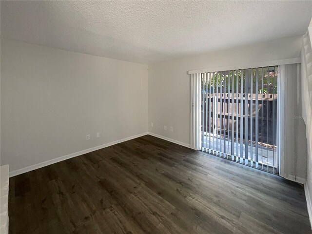 5126 Picadilly Circus Ct Unit 11, Orlando, FL 32839 - unfurnished room with dark wood-type flooring, baseboards, and a textured ceiling
