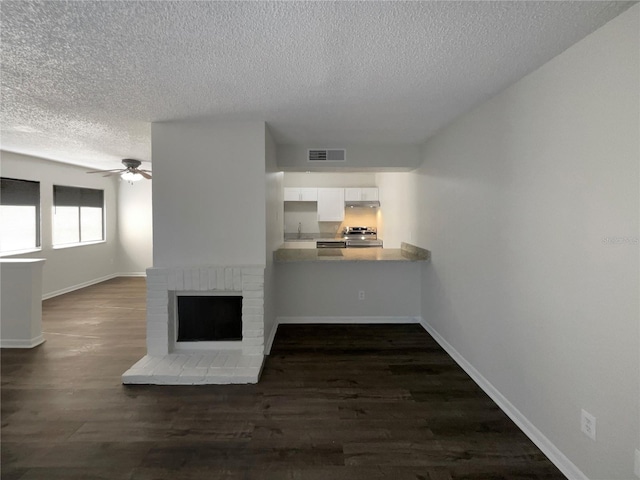 5126 Picadilly Circus Ct Unit 11, Orlando, FL 32839 - unfurnished living room featuring dark wood-type flooring, a textured ceiling, a ceiling fan, and visible vents
