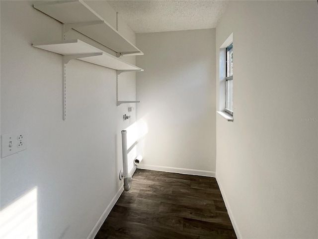 5126 Picadilly Circus Ct Unit 11, Orlando, FL 32839 - washroom with dark wood-type flooring, laundry area, baseboards, and a textured ceiling