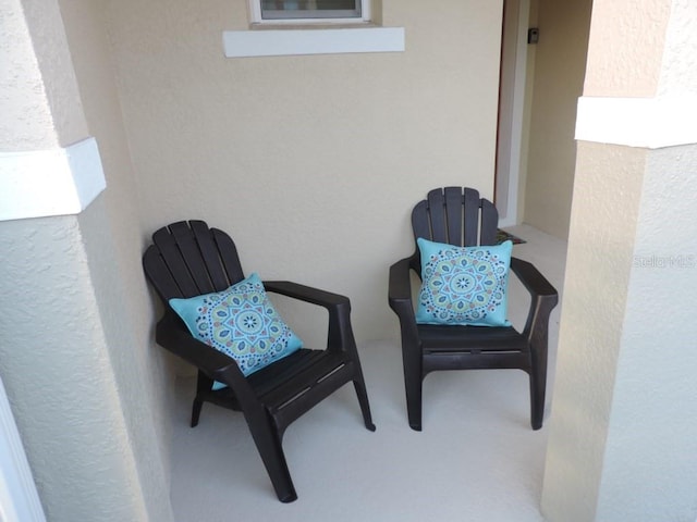 exterior space with carpet and a textured wall