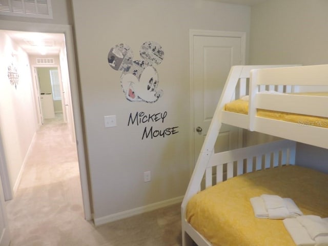 carpeted bedroom featuring visible vents and baseboards