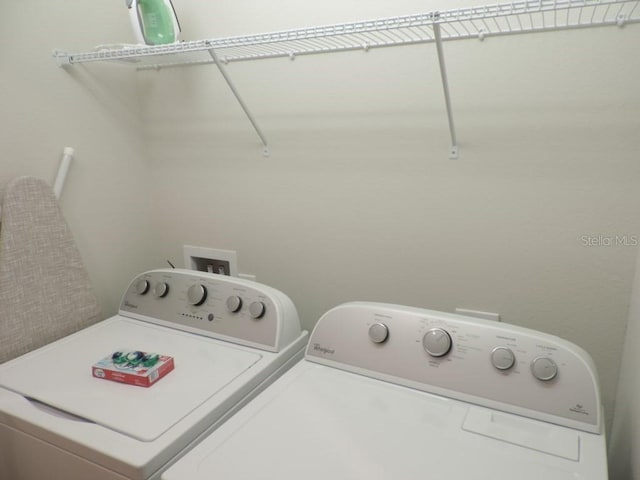 clothes washing area featuring separate washer and dryer