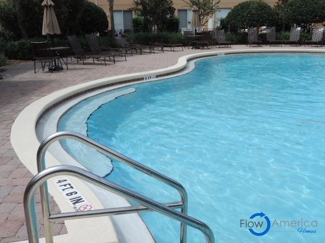 view of pool featuring a patio area and fence