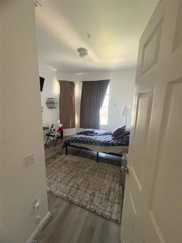 bedroom featuring wood finished floors