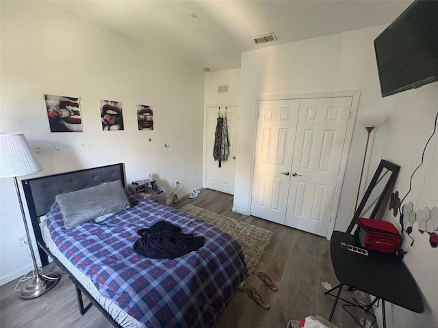 bedroom featuring visible vents, a closet, and wood finished floors