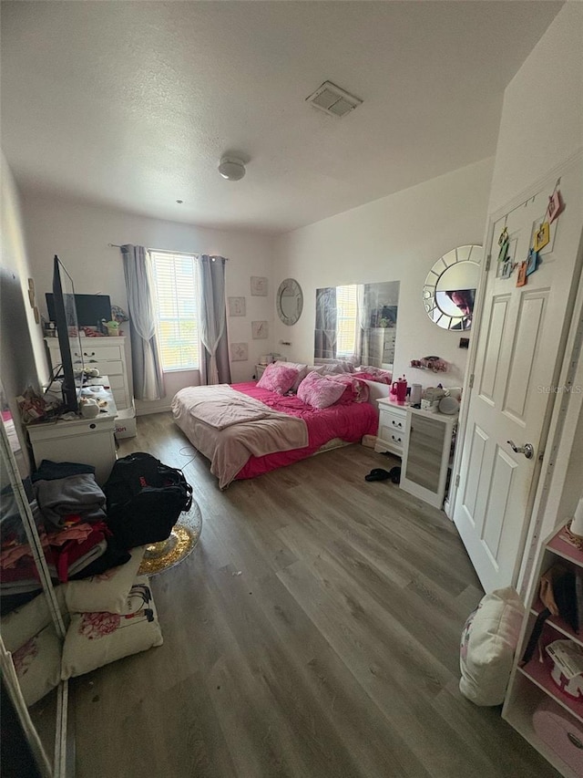 bedroom with wood finished floors and visible vents