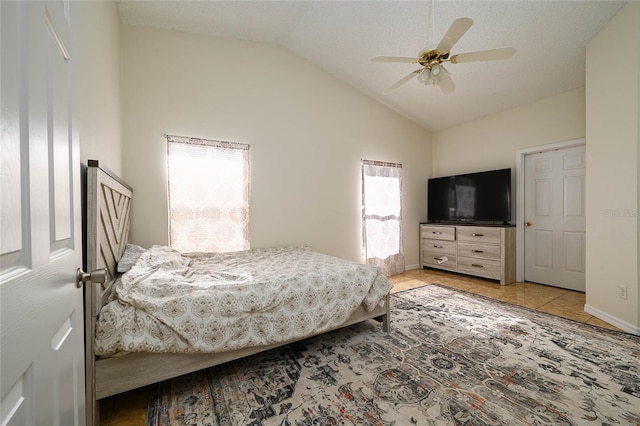 tiled bedroom featuring baseboards, vaulted ceiling, and a ceiling fan