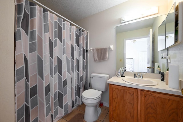 full bath featuring a textured ceiling, vanity, toilet, curtained shower, and tile patterned floors