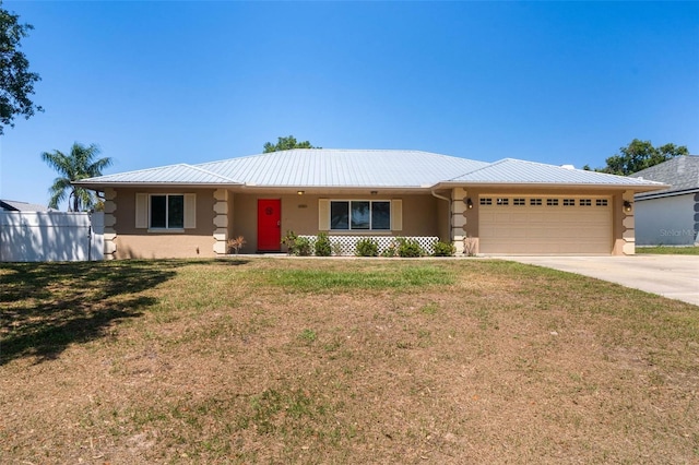 ranch-style house with concrete driveway, stucco siding, a front lawn, an attached garage, and fence