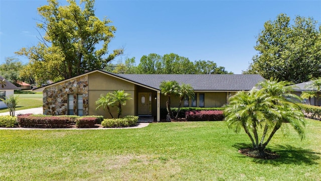 7655 Persian Ct, Orlando, FL 32819 - view of front of home with stucco siding and a front lawn