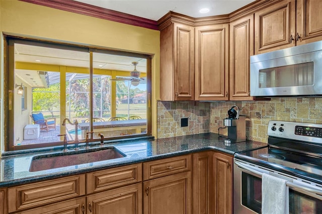 7655 Persian Ct, Orlando, FL 32819 - kitchen with stainless steel appliances, backsplash, a sink, and brown cabinets