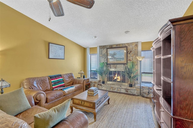 7655 Persian Ct, Orlando, FL 32819 - living area with plenty of natural light, vaulted ceiling, a stone fireplace, and a textured ceiling