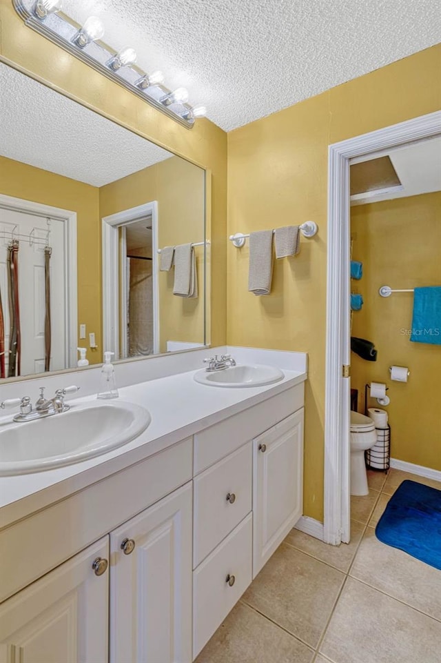7655 Persian Ct, Orlando, FL 32819 - full bathroom featuring double vanity, tile patterned floors, toilet, and a sink