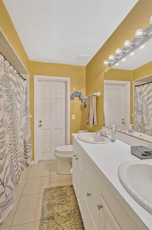 7655 Persian Ct, Orlando, FL 32819 - bathroom featuring toilet, tile patterned floors, a sink, and double vanity