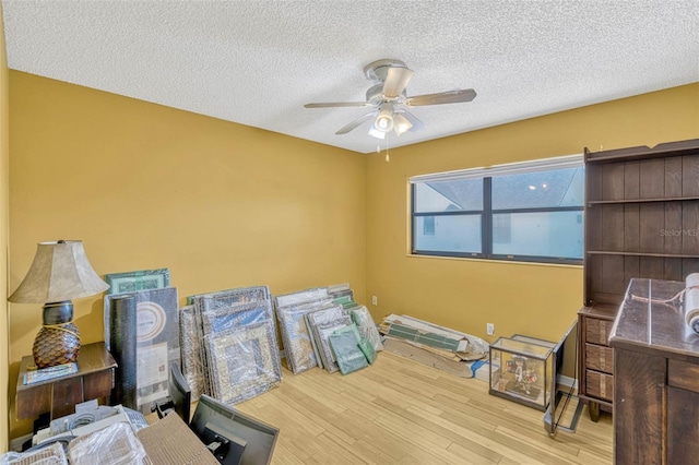 7655 Persian Ct, Orlando, FL 32819 - miscellaneous room with wood finished floors, a textured ceiling, and a ceiling fan